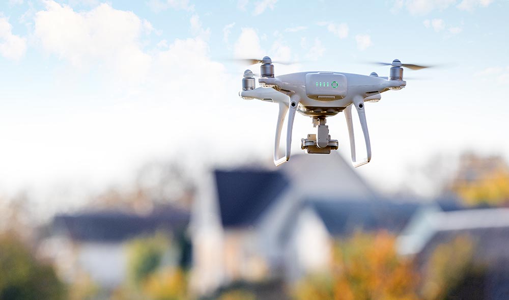 Drone flying over a neighborhood during a home inspection