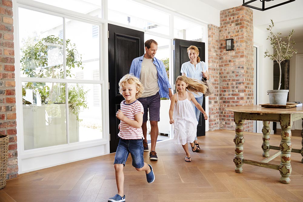 Family of four arriving to their new house after being inspected by our home inspectors